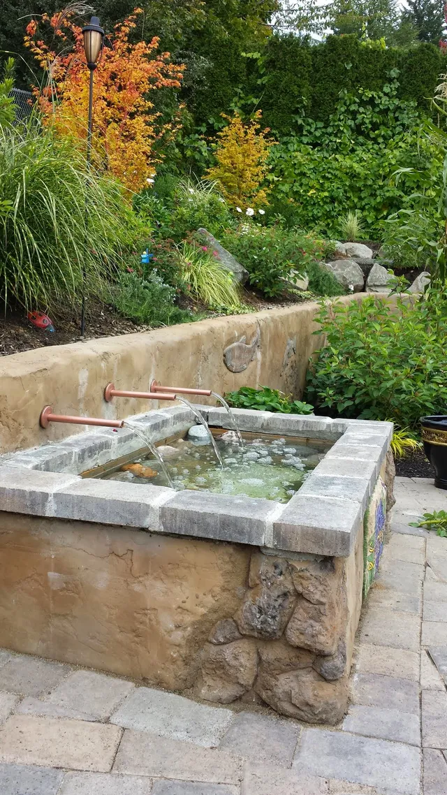 Copper-spout fountain basin with stone trim