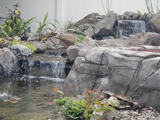 Pond waterfalls with arcing water jets