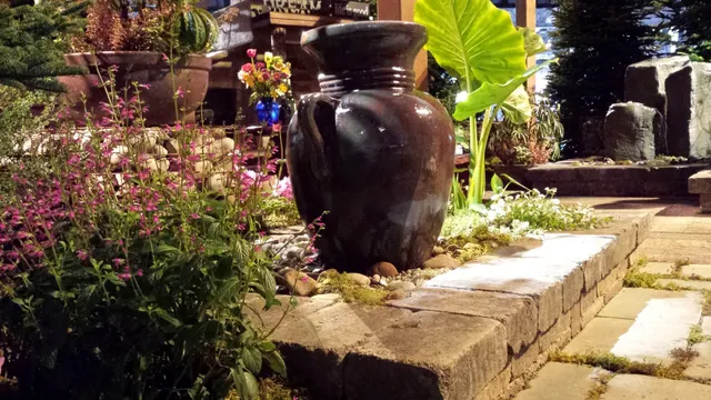 Urn fountain display beside paver steps