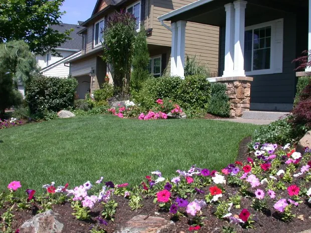 Colorful front-yard planting beds and healthy lawn