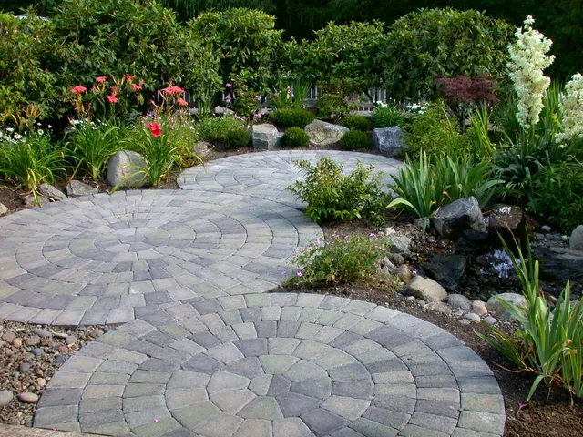 Circular paver medallion walkway bordered by perennials