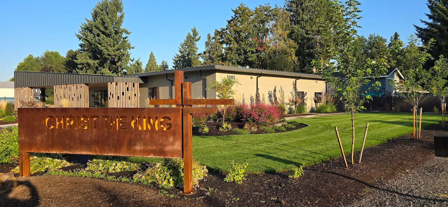 Completed commercial landscape with fresh lawn, plantings, and custom entry signage