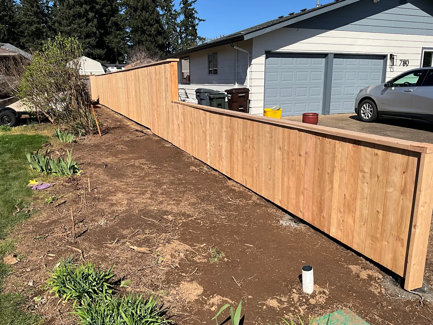 New cedar privacy fence installed along the cleared property line