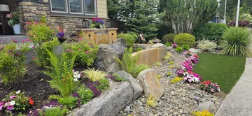 Finished custom water feature with boulders and plantings