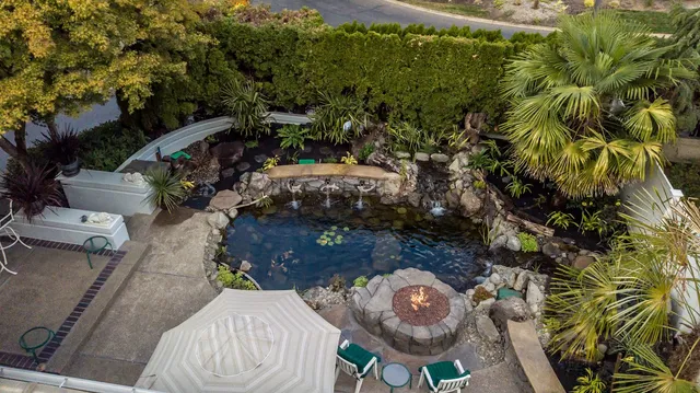 Aerial view of a koi pond with fire pit seating area